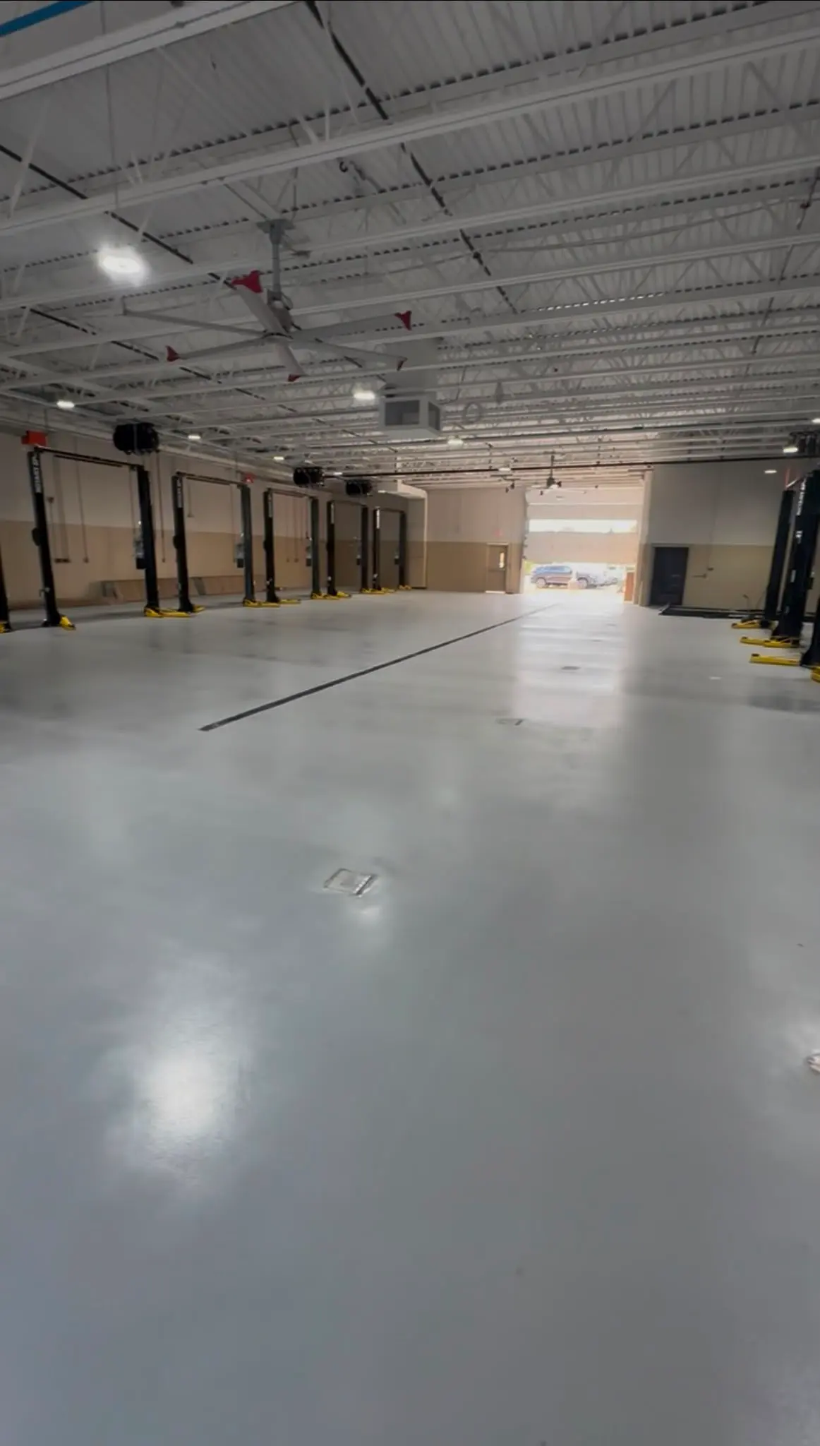 Row of service bays on a gray dealership floor