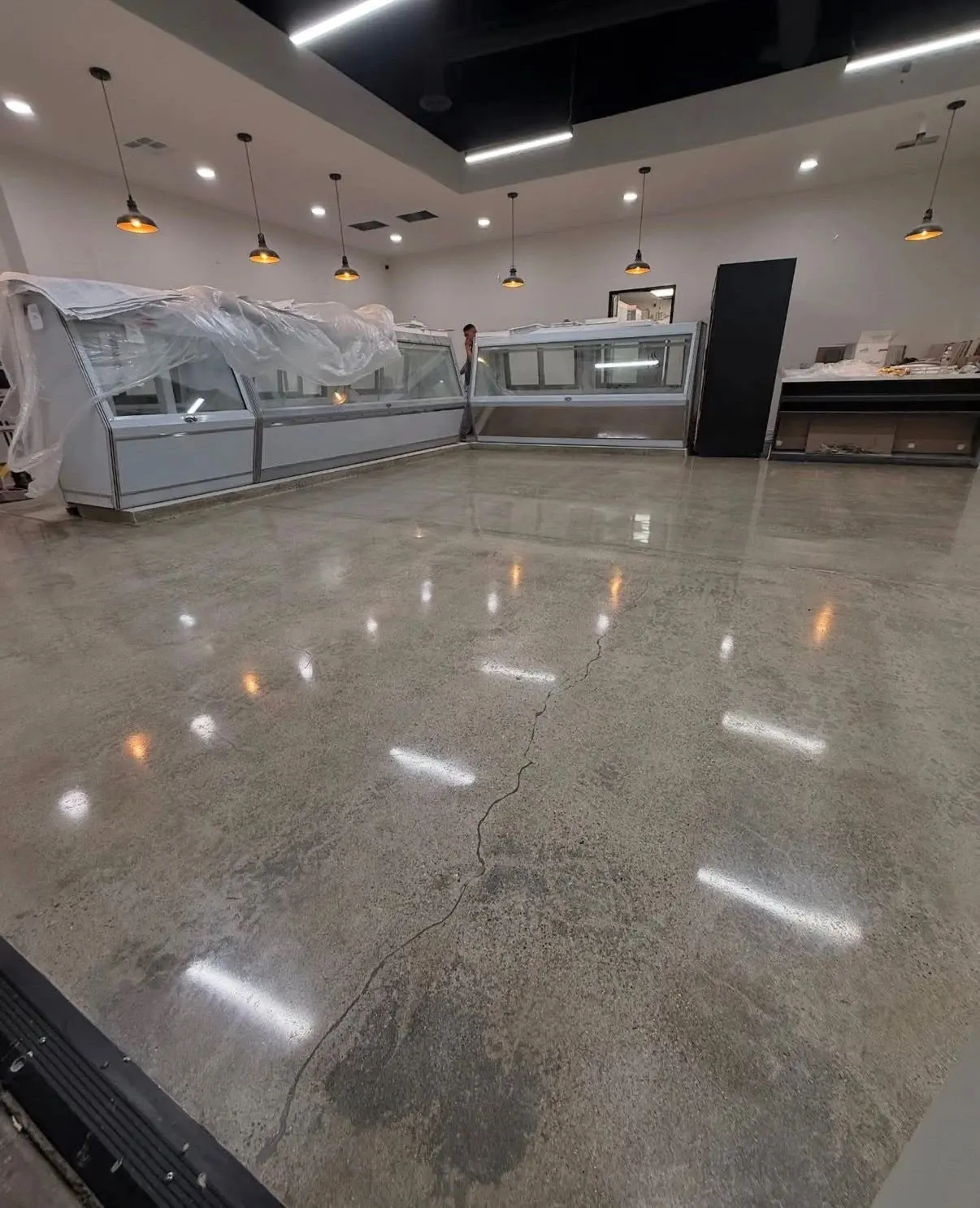 Polished concrete slab in a deli build-out, ground and polished to a reflective finish