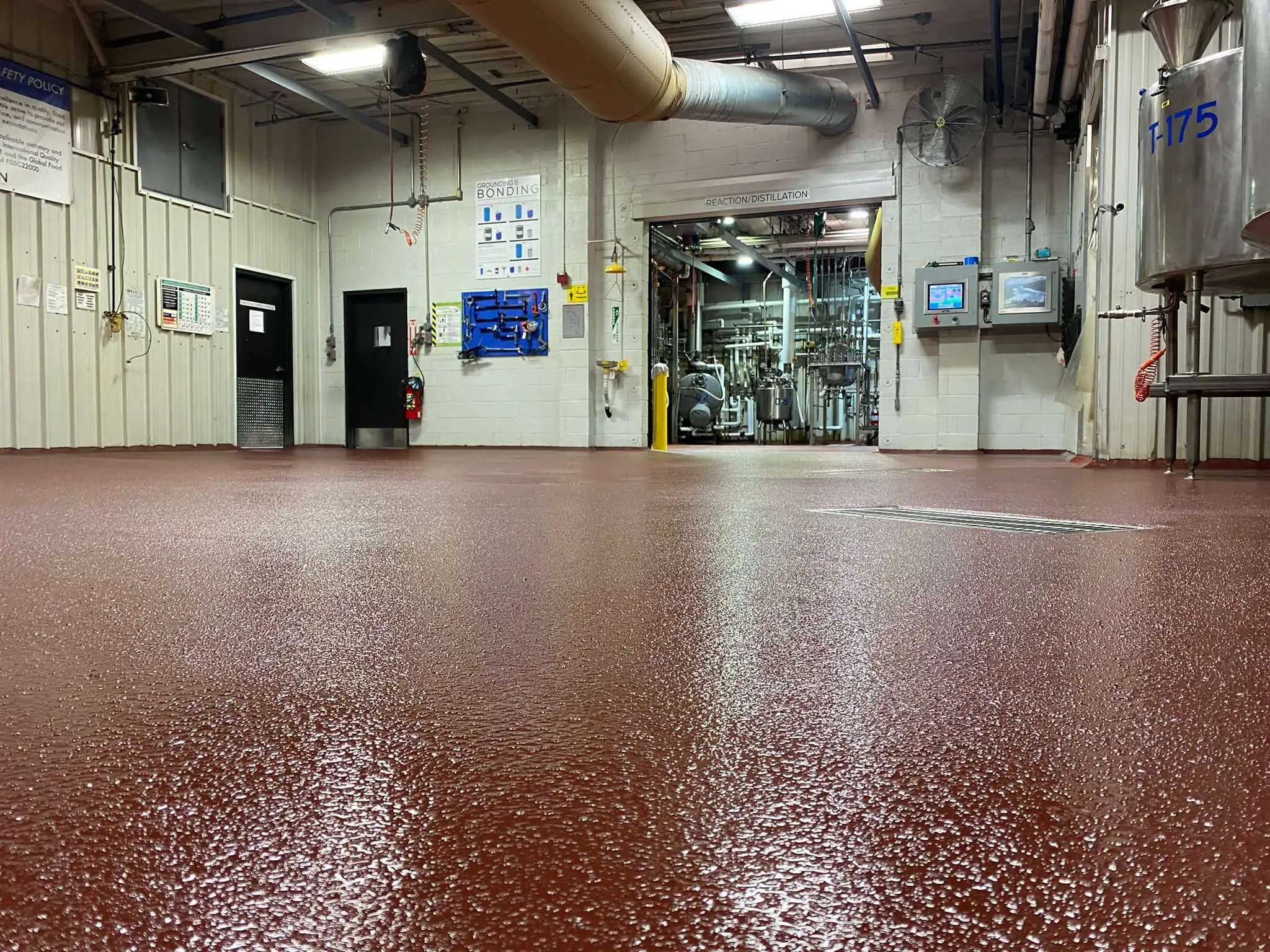 Urethane cement mortar floor, trowelled to depth around process equipment